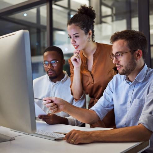 Employees around a computer